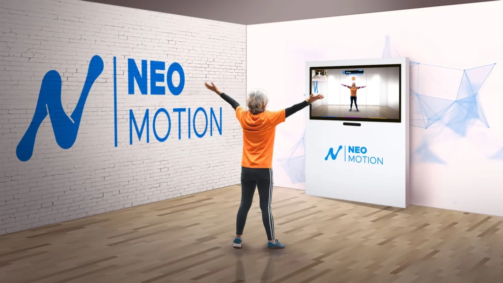 Système Neo-Motion montrant la configuration avec télé et totem, utilisé par un patient pour des exercices interactifs